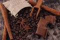 Chocolate, cinnamon sticks  and coffee beans on wooden background Royalty Free Stock Photo