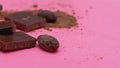 Chocolate, cocoa beans, cocoa powder on a pink background Royalty Free Stock Photo