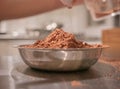 Chocolate cocoa powder in small stainless steel plate.