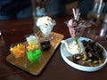 Chocolate and Coconut ice-cream with toping.Cake on wooden table Royalty Free Stock Photo