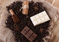 Chocolate, coffee beans, anise and cinnamon  on wooden background Royalty Free Stock Photo
