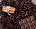 Chocolate, coffee beans, anise and cinnamon on wooden background Royalty Free Stock Photo