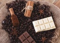 Chocolate, coffee beans, anise and cinnamon on wooden background Royalty Free Stock Photo