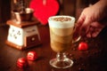 Chocolate coffee cream mousse three chocolates and whipped cream in a tall glass glass and a woman`s hand, on a wooden Royalty Free Stock Photo