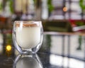 Chocolate coffee pudding in a small glass over lack table in restaurant or cafe. Blurred background