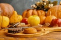 Chocolate cookies and autumn harvest on wooden table. Royalty Free Stock Photo