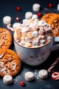 Chocolate cookies, Christmas candies, cocoa in a cup and marshmallow decorations on a gray background. Generative AI Royalty Free Stock Photo