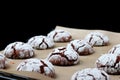 Chocolate cookies with cracks on baking paper and iolated on black. Cracked chocolate biscuits Royalty Free Stock Photo