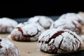 Chocolate cookies with cracks on baking paper and iolated on black. Cracked chocolate biscuits Royalty Free Stock Photo