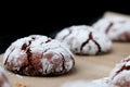 Chocolate cookies with cracks on baking paper and iolated on black. Cracked chocolate biscuits Royalty Free Stock Photo