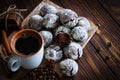 Chocolate cookies and cup of coffee with coffee bean, cocoa powder, cinnamon and star anise on wooden table.