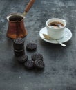 Chocolate cookies with cup and pot of coffee, dark Royalty Free Stock Photo