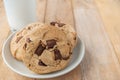 Chocolate cookies and a glass of milk on wood plank table Royalty Free Stock Photo