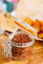 Chocolate Cookies in opened glass jar on wooden table