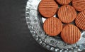 chocolate cookies on plate isolated on black background