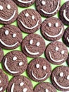 Chocolate cookies with smilies in top.