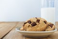 Close up picture of chocolate cookies and a cup of milk on table Royalty Free Stock Photo