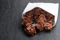 Chocolate corn flake clusters in paper bag on black stone background Royalty Free Stock Photo