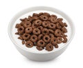 Chocolate corn rings with milk isolated on white background, top view Royalty Free Stock Photo