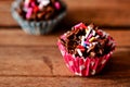Chocolate cornflakes with colourful chocolate rice on a wooden board