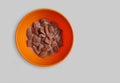 Chocolate cornflakes dipped in chocolate milk in a white bowl in light background with spoon Royalty Free Stock Photo