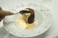 Chocolate coulant with vanilla ice cream being started by spoon. Royalty Free Stock Photo