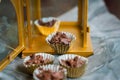 Chocolate Covered Almonds in golden paper cups.