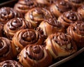 chocolate covered cinnamon buns in a baking pan