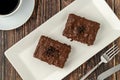 Chocolate covered raisin cake on wooden table with filter coffee Royalty Free Stock Photo