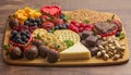 A Chocolate Covered Strawberries and Cheese Sweet Charcuterie Board on a Rustic Wooden Table Royalty Free Stock Photo