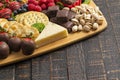 A Chocolate Covered Strawberries and Cheese Sweet Charcuterie Board on a Rustic Wooden Table Royalty Free Stock Photo
