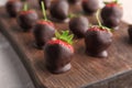 Chocolate covered strawberries on wooden board Royalty Free Stock Photo