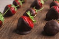 Chocolate covered strawberries on wooden board Royalty Free Stock Photo