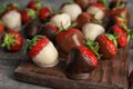 Chocolate covered strawberries on wooden board