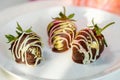 Chocolate covered strawberry on plate Royalty Free Stock Photo