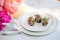 Chocolate covered strawberry on plate Royalty Free Stock Photo