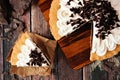 Chocolate cream pie, close up scene with slice removed on dark wood
