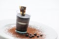Chocolate cream in taster, chocolate desert on white plate with coffee beans and cocoa powder, patisserie, photography for shop