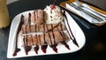 Chocolate crepe served with ice cream and whipping cream Royalty Free Stock Photo