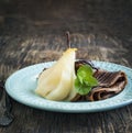 Chocolate crepes with poached pear in syrup Royalty Free Stock Photo