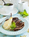 Chocolate crepes with poached pear in syrup Royalty Free Stock Photo