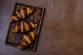 Chocolate croissant and chocolatier on table