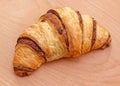 Chocolate croissant on the wooden background