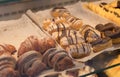 Chocolate croissants and other pastries on the counter in the pastry shop. Fresh pastries. Sweet desserts. sale of