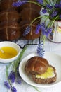 Chocolate cross buns served with butter and honey. Traditional Easter baking.