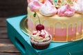 Chocolate cupcake with berry sauce, whipped cream and fresh cherry on top. Cake on the background Royalty Free Stock Photo