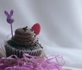 Chocolate cupcake with blurred Easter objects Royalty Free Stock Photo