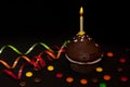 Chocolate cupcake with a burning candle Royalty Free Stock Photo
