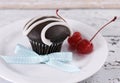 Chocolate cupcake with festive red maraschino cherries