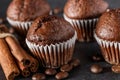 Chocolate cupcake with icing and chocolate bar in Dark lighting,Homemade delicious chocolate muffin on wooden background close-up